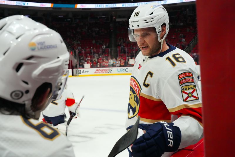 Mar 14, 2024; Raleigh, North Carolina, USA; Florida Panthers center Aleksander Barkov (16) and defenseman Brandon Montour (62) talk during the warmups against the Carolina Hurricanes at PNC Arena. Mandatory Credit: James Guillory-USA TODAY Sports