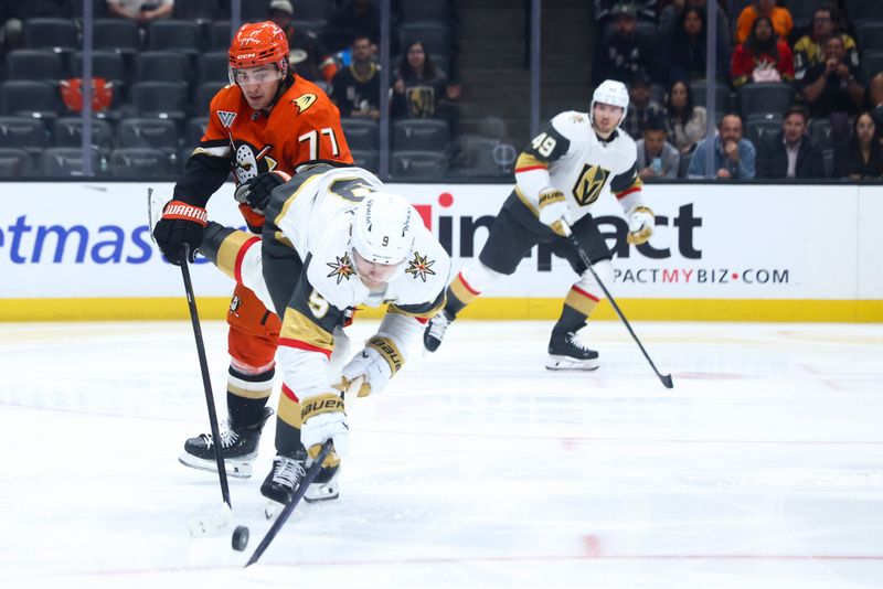 Nov 13, 2024; Anaheim, California, USA; Anaheim Ducks right wing Frank Vatrano (77) and Vegas Golden Knights center Jack Eichel (9) battle for the puck during second period of a hockey game at Honda Center. Mandatory Credit: Jessica Alcheh-Imagn Images