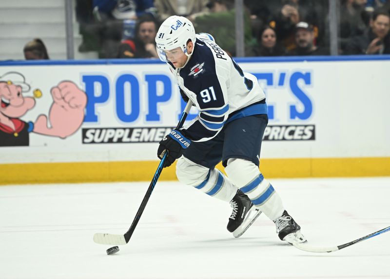 Feb 25, 2026; Vancouver, British Columbia, CAN; Winnipeg Jets center Cole Perfetti (91) skates with the puck against against the Vancouver Canucks during first period at Rogers Arena. Mandatory Credit: Simon Fearn-Imagn Images