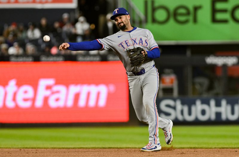 May 21, 2025; Bronx, New York, USA; Texas Rangers second baseman Marcus Semien (2) throws to first for an out during the fourth inning against the New York Yankees at Yankee Stadium. Mandatory Credit: John Jones-Imagn Images