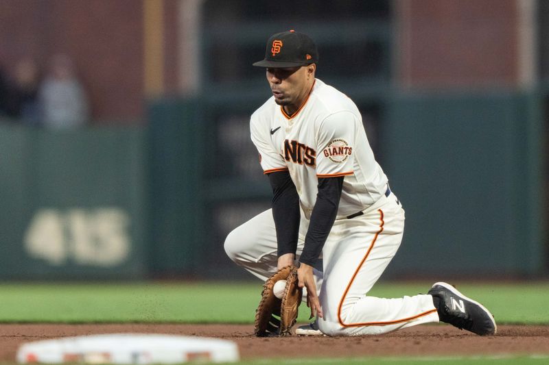 Jul 3, 2023; San Francisco, California, USA;  San Francisco Giants first baseman LaMonte Wade Jr. (31) stops the ball during the eighth inning against the Seattle Mariners at Oracle Park. Mandatory Credit: Stan Szeto-USA TODAY Sports