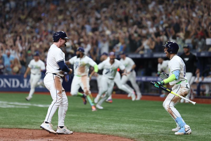 Aug 16, 2024; St. Petersburg, Florida, USA; Tampa Bay Rays outfielder Jonny DeLuca (21) scores a run against the Arizona Diamondbacks in the ninth inning at Tropicana Field. Mandatory Credit: Nathan Ray Seebeck-USA TODAY Sports