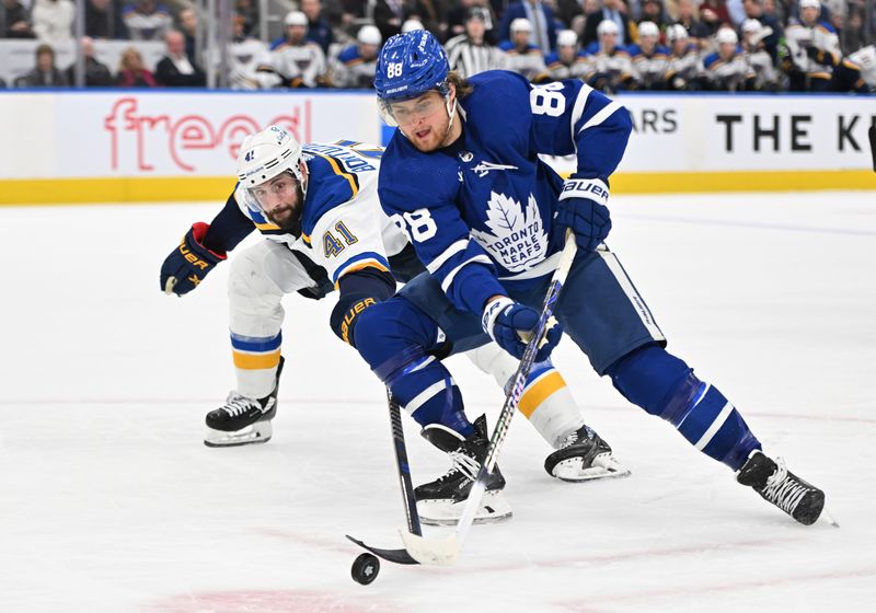 Jan 3, 2023; Toronto, Ontario, CAN; Toronto Maple Leafs forward William Nylander (88) moves the puck past St. Louis Blues defenseman Robert Bortuzzo (42) in the third  period at Scotiabank Arena. Mandatory Credit: Dan Hamilton-USA TODAY Sports