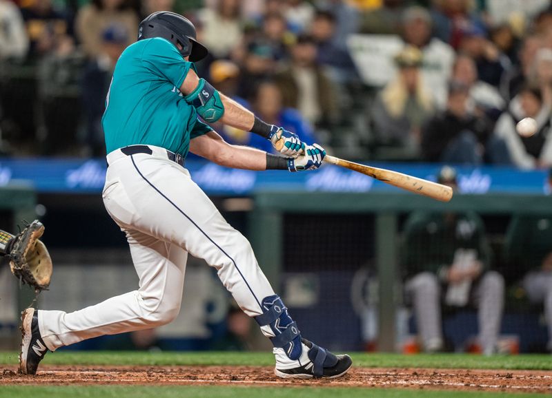 Sep 28, 2024; Seattle, Washington, USA; Seattle Mariners catcher hits a solo home run during the fourth inning against the Oakland Athletics at T-Mobile Park. Mandatory Credit: Stephen Brashear-Imagn Images