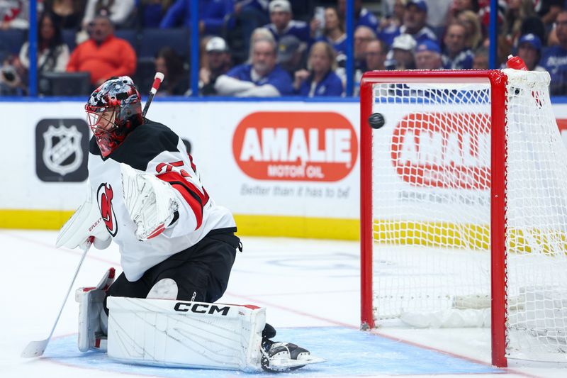 Nov 16, 2024; Tampa, Florida, USA; a shot from Tampa Bay Lightning defenseman Victor Hedman (77) (not pictured) goes past New Jersey Devils goaltender Jacob Markstrom (25) for a goal in the third period at Amalie Arena. Mandatory Credit: Nathan Ray Seebeck-Imagn Images