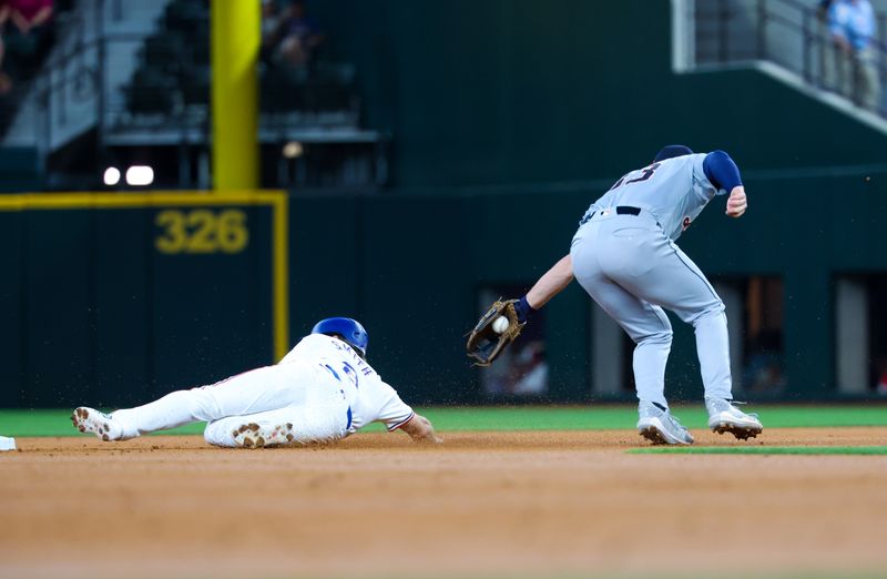 Jun 5, 2024; Arlington, Texas, USA;  Detroit Tigers second baseman Colt Keith (33) cannot tag out Texas Rangers third base Josh Smith (8) at second base during the first inning at Globe Life Field. Mandatory Credit: Kevin Jairaj-USA TODAY Sports