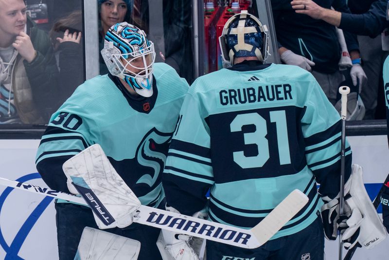 Dec 30, 2022; Seattle, Washington, USA; Seattle Kraken starting goalie Philipp Grubauer (31) is replaced by goalie Martin Jones (30) after giving up three goals during the first period against the Edmonton Oilers at Climate Pledge Arena. Mandatory Credit: Stephen Brashear-USA TODAY Sports