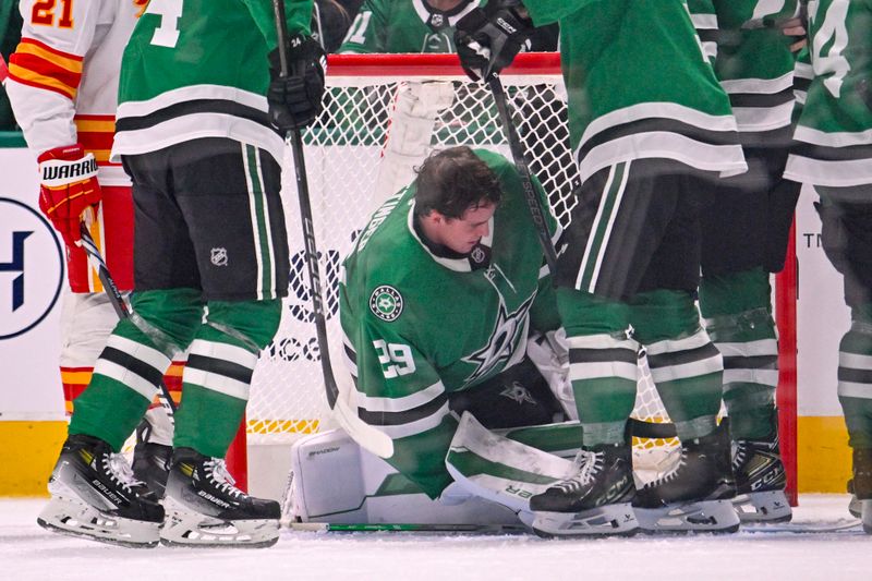 Mar 6, 2025; Dallas, Texas, USA; Dallas Stars goaltender Jake Oettinger (29) loses his helmet as he faces the Calgary Flames attack during the second period at the American Airlines Center. Mandatory Credit: Jerome Miron-Imagn Images