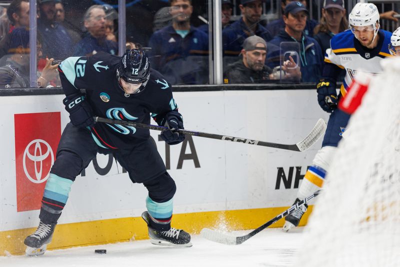 Oct 8, 2024; Seattle, Washington, USA; Seattle Kraken left wing Tye Kartye (12) collects the puck against the St. Louis Blues during the first period at Climate Pledge Arena. Mandatory Credit: Caean Couto-Imagn Images