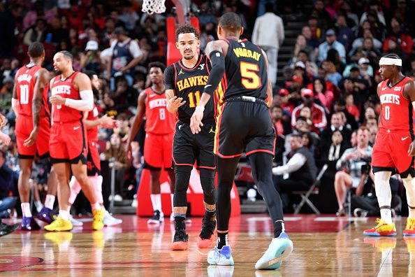 HOUSTON, TX - DECEMBER 20:   Trae Young #11 of the Atlanta Hawks is congratulated during the game against the Houston Rockets on December 20, 2023 at the Toyota Center in Houston, Texas. NOTE TO USER: User expressly acknowledges and agrees that, by downloading and or using this photograph, User is consenting to the terms and conditions of the Getty Images License Agreement. Mandatory Copyright Notice: Copyright 2023 NBAE (Photo by Logan Riely/NBAE via Getty Images)