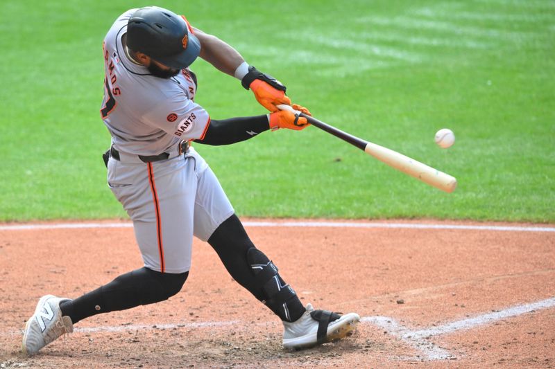Jul 6, 2024; Cleveland, Ohio, USA; San Francisco Giants center fielder Heliot Ramos (17) singles in the fifth inning against the Cleveland Guardians at Progressive Field. Mandatory Credit: David Richard-USA TODAY Sports