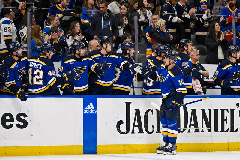 Nov 30, 2023; St. Louis, Missouri, USA;  St. Louis Blues center Brayden Schenn (10) is congratulated by teammates after scoring against the Buffalo Sabres during the first period at Enterprise Center. Mandatory Credit: Jeff Curry-USA TODAY Sports