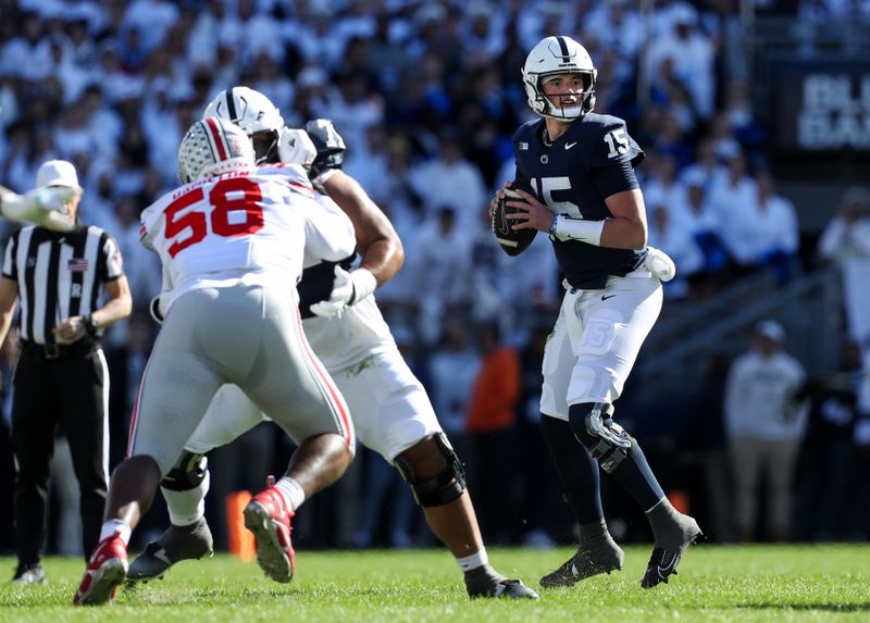 Nov 2, 2024; University Park, Pennsylvania, USA; Penn State Nittany Lions quarterback Drew Allar (15) drops back in the pocket while looking to throw a pass during the first quarter against the Ohio State Buckeyes at Beaver Stadium. Mandatory Credit: Matthew O'Haren-Imagn Images