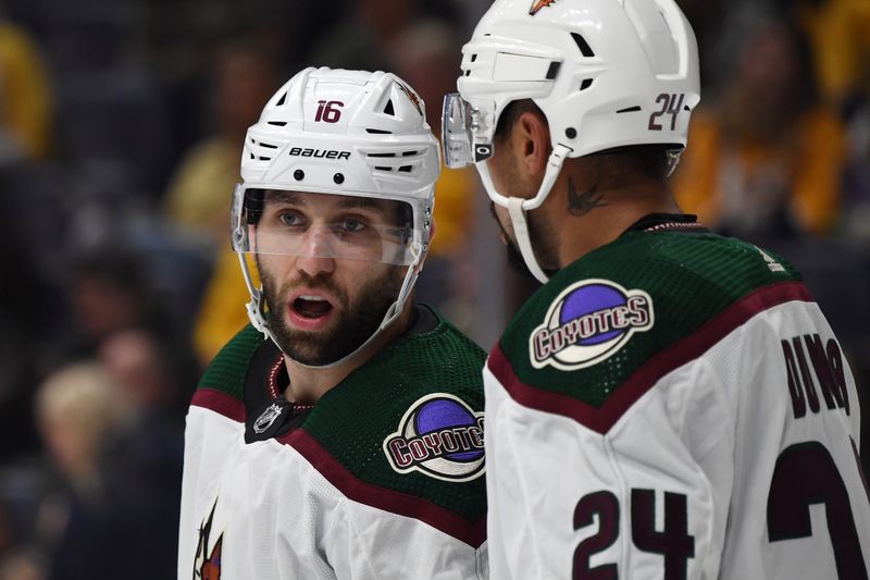 Feb 10, 2024; Nashville, Tennessee, USA; Arizona Coyotes left wing Jason Zucker (16) talks with defenseman Matt Dumba (24) during the first period against the Nashville Predators at Bridgestone Arena. Mandatory Credit: Christopher Hanewinckel-USA TODAY Sports