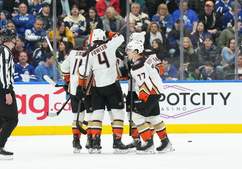 Feb 17, 2024; Toronto, Ontario, CAN; Anaheim Ducks right wing Frank Vatrano (77) scores a goal and celebrates with defenceman Cam Fowler (4) during the first period at Scotiabank Arena. Mandatory Credit: Nick Turchiaro-USA TODAY Sports