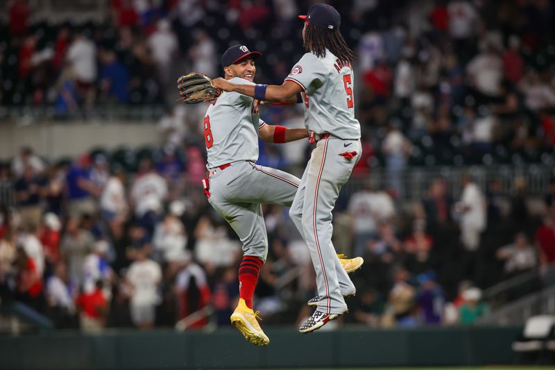 May 30, 2024; Atlanta, Georgia, USA; Washington Nationals left fielder Eddie Rosario (8) and shortstop CJ Abrams (5) celebrate after a victory against the Atlanta Braves at Truist Park. Mandatory Credit: Brett Davis-USA TODAY Sports