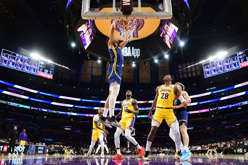 LOS ANGELES, CA - APRIL 9: Trayce Jackson-Davis #32 of the Golden State Warriors  dunks the ball during the game against the Los Angeles Lakers on April 9, 2024 at Crypto.Com Arena in Los Angeles, California. NOTE TO USER: User expressly acknowledges and agrees that, by downloading and/or using this Photograph, user is consenting to the terms and conditions of the Getty Images License Agreement. Mandatory Copyright Notice: Copyright 2024 NBAE (Photo by Adam Pantozzi/NBAE via Getty Images)