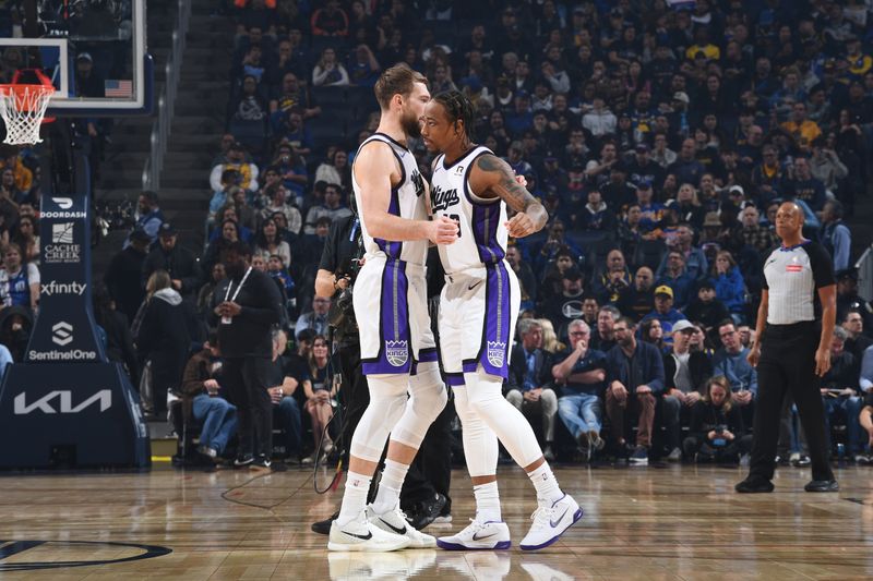 SAN FRANCISCO, CA - JANUARY 5:  Domantas Sabonis #11 embraces DeMar DeRozan #10 of the Sacramento Kings before the game against the Golden State Warriors on January 5, 2025 at Chase Center in San Francisco, California. NOTE TO USER: User expressly acknowledges and agrees that, by downloading and or using this photograph, user is consenting to the terms and conditions of Getty Images License Agreement. Mandatory Copyright Notice: Copyright 2025 NBAE (Photo by Noah Graham/NBAE via Getty Images)