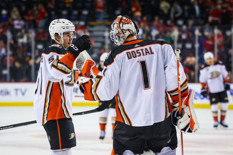 Apr 2, 2024; Calgary, Alberta, CAN; Anaheim Ducks goaltender Lukas Dostal (1) celebrates win with Anaheim Ducks defenseman Olen Zellweger (51) after defeating the Calgary Flames at Scotiabank Saddledome. Mandatory Credit: Sergei Belski-USA TODAY Sports