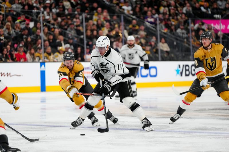 Dec 28, 2023; Las Vegas, Nevada, USA; Los Angeles Kings center Anze Kopitar (11) skates with the puck against Vegas Golden Knights right wing Mark Stone (61) during the third period at T-Mobile Arena. Mandatory Credit: Lucas Peltier-USA TODAY Sports