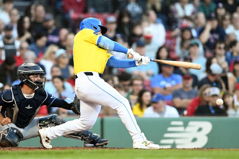 Sep 28, 2024; Boston, Massachusetts, USA; Boston Red Sox catcher Mickey Gasper (77) hits for a fielders choice against the Tampa Bay Rays during the fourth inning at Fenway Park. Mandatory Credit: Brian Fluharty-Imagn Images