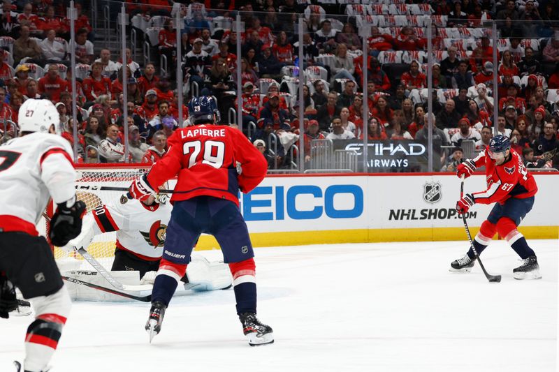 Apr 7, 2024; Washington, District of Columbia, USA; Washington Capitals left wing Max Pacioretty (67) scores a goal on Ottawa Senators goaltender Joonas Korpisalo (70) in the first period at Capital One Arena. Mandatory Credit: Geoff Burke-USA TODAY Sports