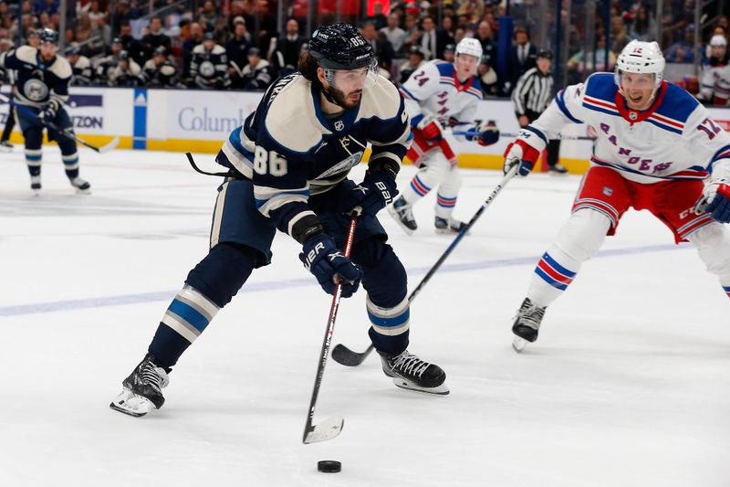 Oct 14, 2023; Columbus, Ohio, USA; Columbus Blue Jackets right wing Kirill Marchenko (86) looks to pass as New York Rangers center Nick Bonino (12) defends during the first period at Nationwide Arena. Mandatory Credit: Russell LaBounty-USA TODAY Sports