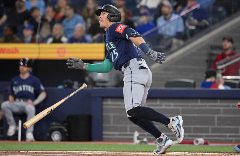 Apr 20, 2025; Toronto, Ontario, CAN;  Seattle Mariners shortstop Ryan Moore (25) hits a solo home run against the Toronto Blue Jays in the first inning at Rogers Centre. Mandatory Credit: Dan Hamilton-Imagn Images