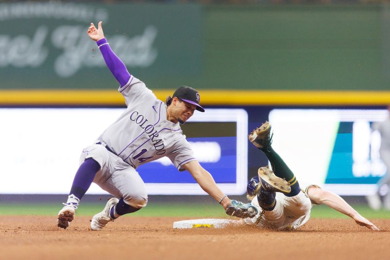 Aug 8, 2023; Milwaukee, Wisconsin, USA;  Milwaukee Brewers center fielder Joey Wiemer (28) is tagged out by Colorado Rockies shortstop Ezequiel Tovar (14) while attempting to steal second base during the fifth inning at American Family Field. Mandatory Credit: Jeff Hanisch-USA TODAY Sports