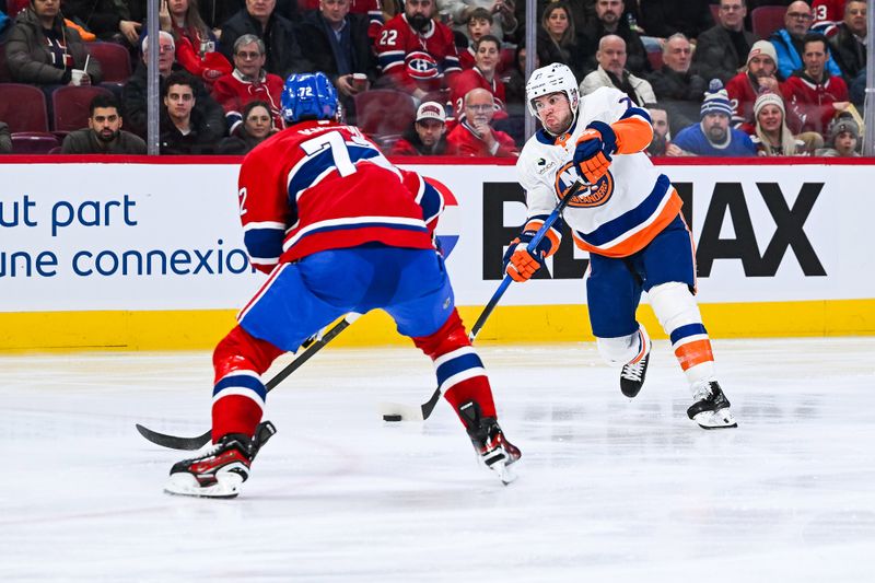 Feb 26, 2026; Montreal, Quebec, CAN; New York Islanders defenseman Tony DeAngelo (77) shoots the puck agianst Montreal Canadiens defenseman Arber Xhekaj (72) during the third period at Bell Centre. Mandatory Credit: David Kirouac-Imagn Images