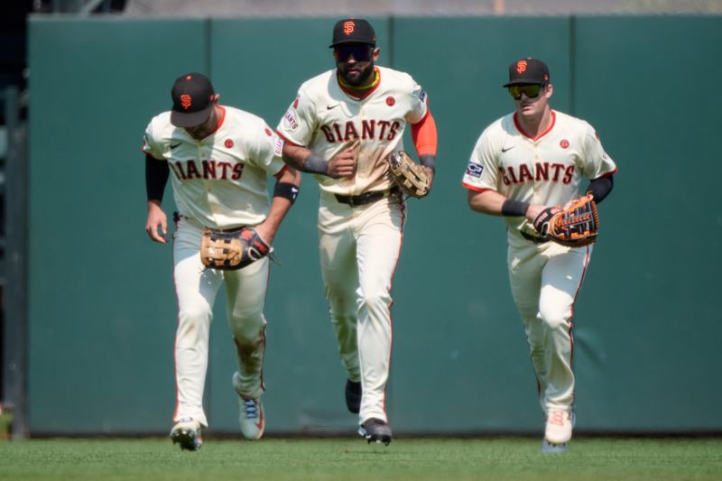 Jul 28, 2024; San Francisco, California, USA; San Francisco Giants outfielders Michael Conforto (8) (left), Derek Hill (48) (center) and Mike Yastrzemski (5) run in from the outfield after the final out of the game against the Colorado Rockies during the ninth inning at Oracle Park. Mandatory Credit: Robert Edwards-USA TODAY Sports