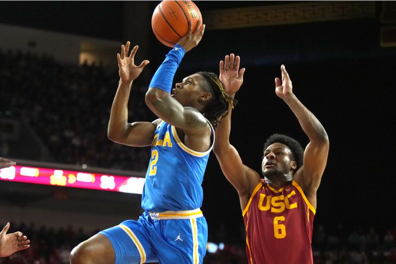 Jan 27, 2024; Los Angeles, California, USA; UCLA Bruins guard Dylan Andrews (2) shoots the ball against Southern California Trojans guard Bronny James (6) in the first half at Galen Center. Mandatory Credit: Kirby Lee-USA TODAY Sports