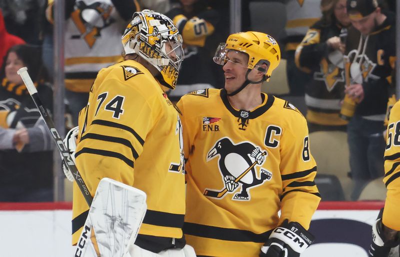 Jan 15, 2026; Pittsburgh, Pennsylvania, USA;  Pittsburgh Penguins goaltender Stuart Skinner (74) and center Sidney Crosby (87) react after defeating the Philadelphia Flyers at PPG Paints Arena. Mandatory Credit: Charles LeClaire-Imagn Images