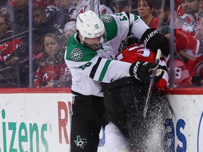 Jan 20, 2024; Newark, New Jersey, USA; Dallas Stars center Craig Smith (15) hits New Jersey Devils defenseman Luke Hughes (43) during the first period at Prudential Center. Mandatory Credit: Ed Mulholland-USA TODAY Sports