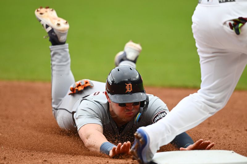 Oct 12, 2024; Cleveland, Ohio, USA; Detroit Tigers first base Spencer Torkelson (20) slides in to third base in the sixth inning against the Cleveland Guardians during game five of the ALDS for the 2024 MLB Playoffs at Progressive Field. Mandatory Credit: Ken Blaze-Imagn Images