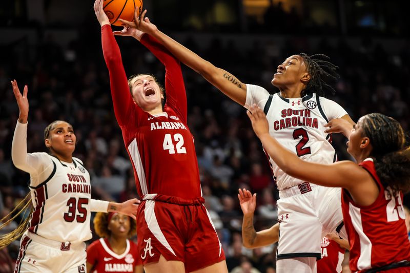 Feb 22, 2024; Columbia, South Carolina, USA; Alabama Crimson Tide forward Meg Newman (42) and South Carolina Gamecocks forward Ashlyn Watkins (2) battle for a rebound in the first half at Colonial Life Arena. Mandatory Credit: Jeff Blake-USA TODAY Sports