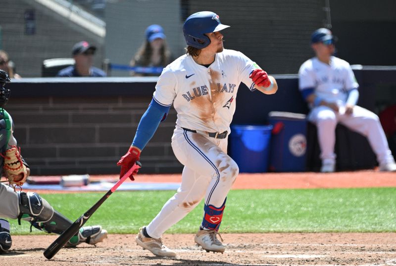 Jun 16, 2024; Toronto, Ontario, CAN;  Toronto Blue Jays right fielder Addison Barger (47) hits an RBI single against the Cleveland Guardians in the fifth inning at Rogers Centre. Mandatory Credit: Dan Hamilton-USA TODAY Sports