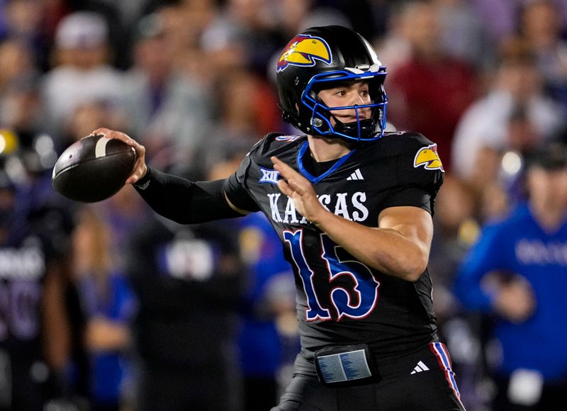 Nov 18, 2023; Lawrence, Kansas, USA; Kansas Jayhawks quarterback Cole Ballard (15) throws a pass during the first half against the Kansas State Wildcats at David Booth Kansas Memorial Stadium. Mandatory Credit: Jay Biggerstaff-USA TODAY Sports