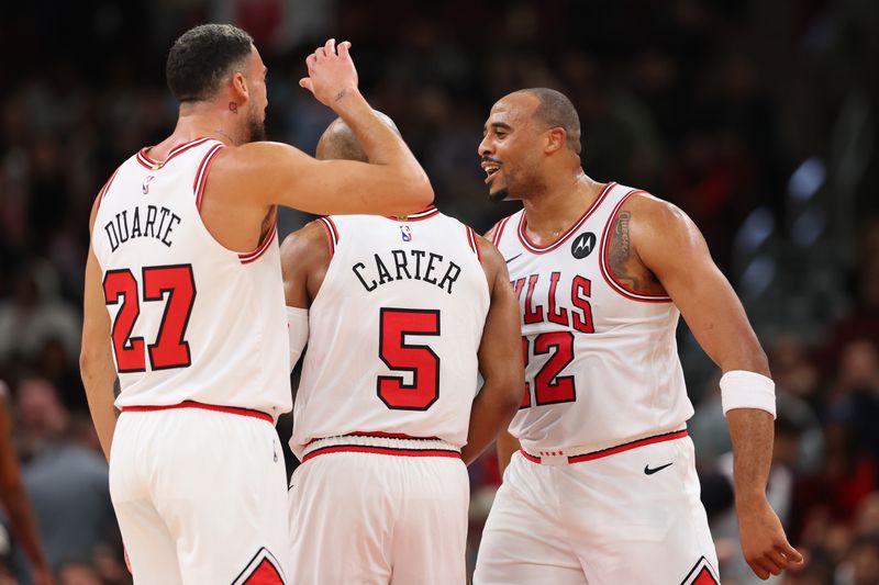 CHICAGO, ILLINOIS - OCTOBER 16: Jevon Carter #5 of the Chicago Bulls celebrates with Chris Duarte #27 and Talen Horton-Tucker #22 after a three pointer against the Minnesota Timberwolves during the second half of a preseason game at the United Center on October 16, 2024 in Chicago, Illinois. NOTE TO USER: User expressly acknowledges and agrees that, by downloading and or using this photograph, User is consenting to the terms and conditions of the Getty Images License Agreement.  (Photo by Michael Reaves/Getty Images)