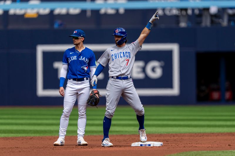 Aug 13, 2023; Toronto, Ontario, CAN; Chicago Cubs shortstop Dansby Swanson (7) celebrates hitting a RBI double against the Toronto Blue Jays during the first inning at Rogers Centre. Mandatory Credit: Kevin Sousa-USA TODAY Sports