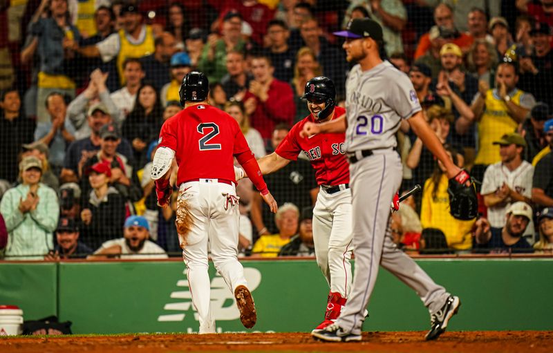 Jun 14, 2023; Boston, Massachusetts, USA; Boston Red Sox designated hitter Justin Turner (2) is congratulated after scoring against the Colorado Rockies in the seventh inning at Fenway Park. Mandatory Credit: David Butler II-USA TODAY Sports