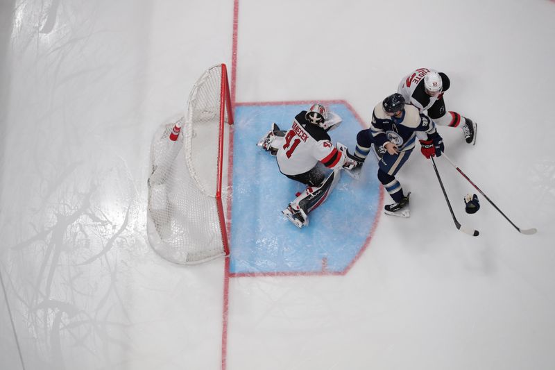 Jan 19, 2024; Columbus, Ohio, USA; New Jersey Devils goalie Vitek Vanecek (41) makes a save as Columbus Blue Jackets center Jack Roslovic (96) looks for a rebound during the first period at Nationwide Arena. Mandatory Credit: Russell LaBounty-USA TODAY Sports