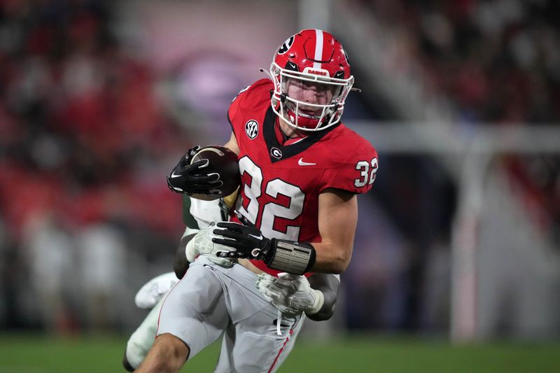 Sep 23, 2023; Athens, Georgia, USA; Georgia Bulldogs running back Cash Jones (32) carries the ball against UAB Blazers linebacker Everett Roussaw Jr. (27) in the first half at Sanford Stadium. Mandatory Credit: Kirby Lee-USA TODAY Sports