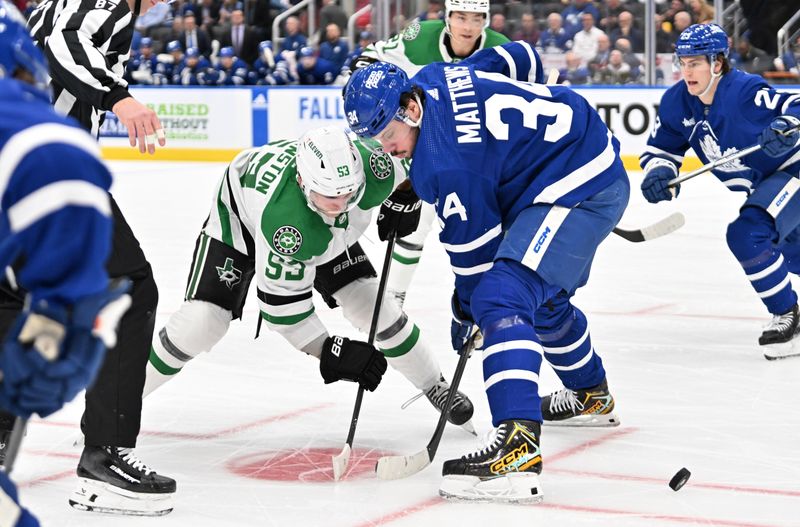 Feb 7, 2024; Toronto, Ontario, CAN; Toronto Maple Leafs forward Auston Matthews (34) wins a faceoff against Dallas Stars forward Wyatt Johnston (53) in the first period at Scotiabank Arena. Mandatory Credit: Dan Hamilton-USA TODAY Sports