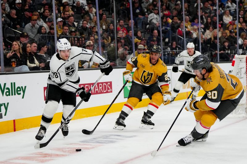 Dec 28, 2023; Las Vegas, Nevada, USA; Los Angeles Kings right wing Alex Laferriere (78) moves the puck against Vegas Golden Knights defenseman Alec Martinez (23) and center Chandler Stephenson (20) during the third period at T-Mobile Arena. Mandatory Credit: Lucas Peltier-USA TODAY Sports