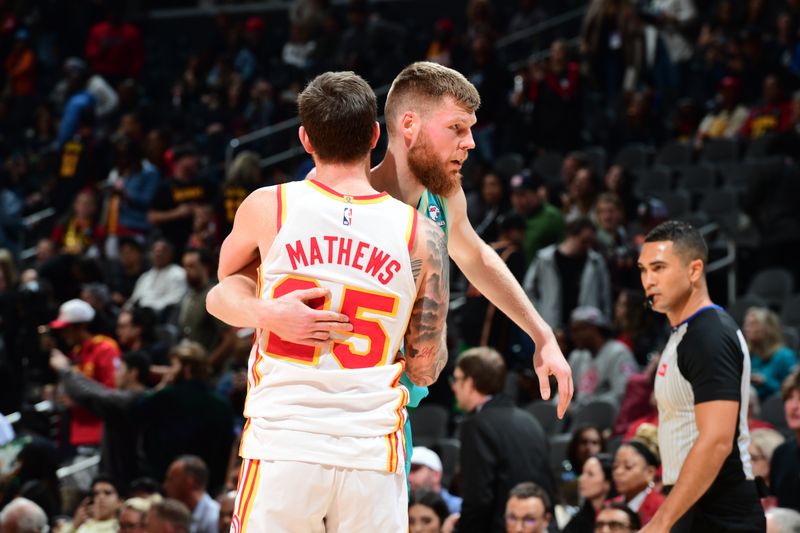 ATLANTA, GA - MARCH 23: Davis Bertans #9 of the Charlotte Hornets and Garrison Mathews #25 of the Atlanta Hawks embrace after the game on March 23, 2024 at State Farm Arena in Atlanta, Georgia.  NOTE TO USER: User expressly acknowledges and agrees that, by downloading and/or using this Photograph, user is consenting to the terms and conditions of the Getty Images License Agreement. Mandatory Copyright Notice: Copyright 2024 NBAE (Photo by Scott Cunningham/NBAE via Getty Images)