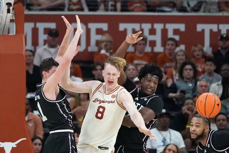 Jan 3, 2026; Austin, Texas, USA; (Editors Notes: Caption Correction) Texas Longhorns center Matas Vokietaitis (8) is blocked by Mississippi State Bulldogs forward Brandon Walker (4) and forward Sergej Macura (11) during overtime at Moody Center. Mandatory Credit: Dustin Safranek-Imagn Images