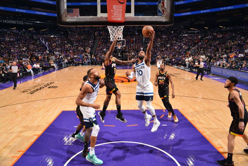 PHOENIX, AZ - APRIL 4: Mike Conley #10 of the Minnesota Timberwolves drives to the basket during the game against the Phoenix Suns during Round 1 Game 4 of the 2024 NBA Playoffs on April 4, 2023 at Footprint Center in Phoenix, Arizona. NOTE TO USER: User expressly acknowledges and agrees that, by downloading and or using this photograph, user is consenting to the terms and conditions of the Getty Images License Agreement. Mandatory Copyright Notice: Copyright 2024 NBAE (Photo by Barry Gossage/NBAE via Getty Images)