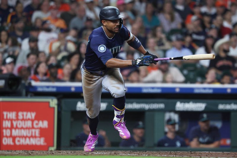 Sep 20, 2025; Houston, Texas, USA; Seattle Mariners center fielder Julio Rodriguez (44) hits a single during the fifth inning against the Houston Astros at Daikin Park. Mandatory Credit: Troy Taormina-Imagn Images