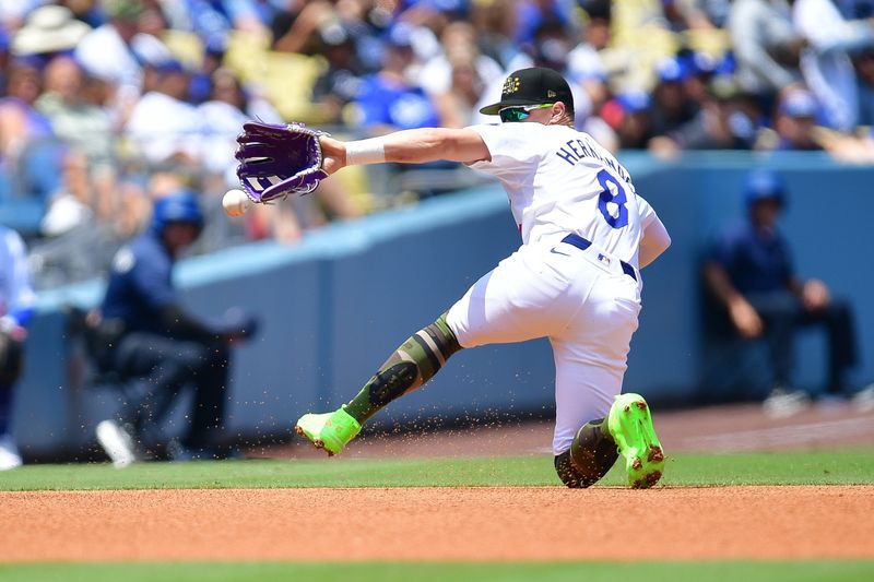 May 19, 2024; Los Angeles, California, USA; Los Angeles Dodgers third baseman Enrique Hernandez (8) misses catching the double of Cincinnati Reds catcher Luke Maile (22) during the third inning at Dodger Stadium. Mandatory Credit: Gary A. Vasquez-USA TODAY Sports